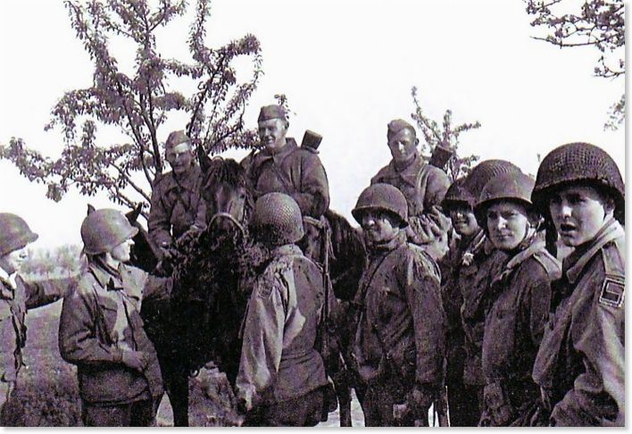 Figure 8. Craig Patrol 1645 (4:30 PM). Major Fred W. Craig, Hq Co 2nd B 273rd Inf Rgt, second from the left, reaches out to a Soviet soldier on his horse. His patrol had been searching for the Kotzebue patrol when it encountered the Russians at Clanzschwitz at 1645 April 25, 1945.